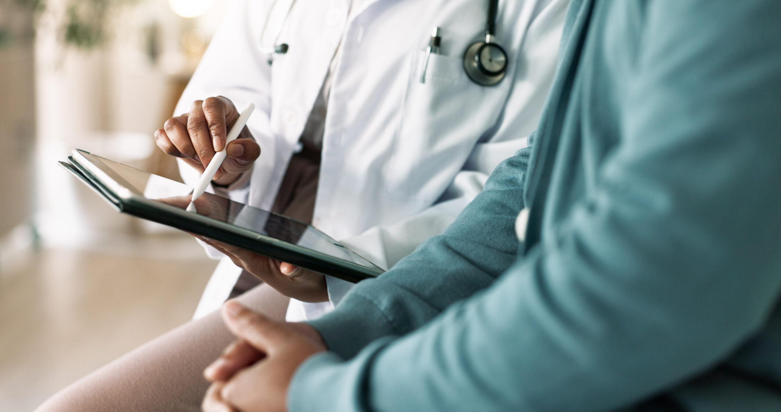 doctor, hands and tablet with patient for consultation, medical advice or procedure at clinic. closeup, healthcare employee and client with technology for health appointment or checklist at hospital